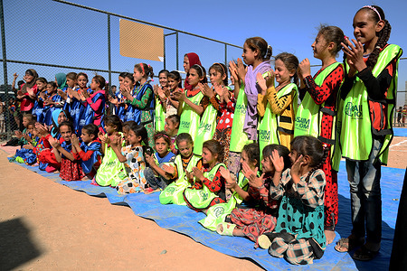 Today these little girls had lots of fun at Haj Ali emergency site's new playground, built with the generous support of the U.S. Association for International Migration. The girls took part in recreational activities that involved teams of two girls each; the girls in each team had one of their legs tied to their partner’s, so they had to work in unison to reach the end line. On the way back, they had to carry a potato in a ladle, without dropping it, to complete the circuit.
