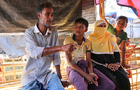 Caption: At a meeting with IOM in the Balukhali settlement, Khairul Amin passionately relays his message for Pope Francis in anticipation of their meeting later the same week on the Rohingya crisis. 

Story: 52-year-old Khairul Amin was very influential in his community in Northern Rakhine State — a well to do jack-of-all-trades with ventures in farming, fishing and retail.
“I even used to have a little shop. Now, I do nothing — just sleeping and eating. I am not in charge of anything more.”
He crossed the border on 5 September but also remembers the massacres of October 2016. His village was heavily targeted at that time and his family suffered greatly. He was even displaced to another village but after a few months he was able to return to his property. When the violence flared up again at the end of August, he could not wait anymore and knew it was time to leave the country to save his, his wife, six children’s lives. They all now live close to each other in the overcrowded refugee settlement of Balukhali.
He said that he would tell the Pope, “there is total discrimination” in Northern Rakhine State. Having lived through waves of violence and oppression, Khairul Amin said he that’s all he would talk about with the Pope.
“Even before, they were oppressing us through extortion but then last year it got violent again.”