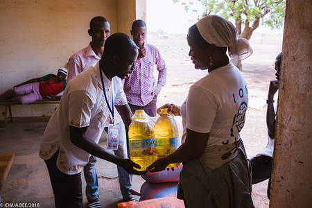 A food and goods distribution to returned migrants in Burkina Faso. More than 2,300 stranded migrants have voluntarily returned to Burkina Faso in the framework of the EU-IOM Joint Initiative for Migrant Protection and Reintegration (as of October 2019). As part of their reintegration, they receive in-kind support such as food and non-food items to help them rebuild their lives and meet their immediate needs.