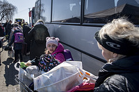 Ukrainian refugees boarding a bus to Italy having just crossed the Medyka border in Poland. March 20, 2022