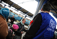 April 16, 2022. IOM staff talks to newly-arrived displaced people at Uzhhorod train station. Millions of people are forced to flee eastern Ukraine in search for safety IOM Gema Cortes