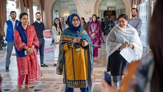 Conference attendees gain a deeper understanding of the vulnerabilities and risks faced by Afghan migrants through a power walk. Photo: IOM/Muhammad Zeeshan Siddiqui 2023